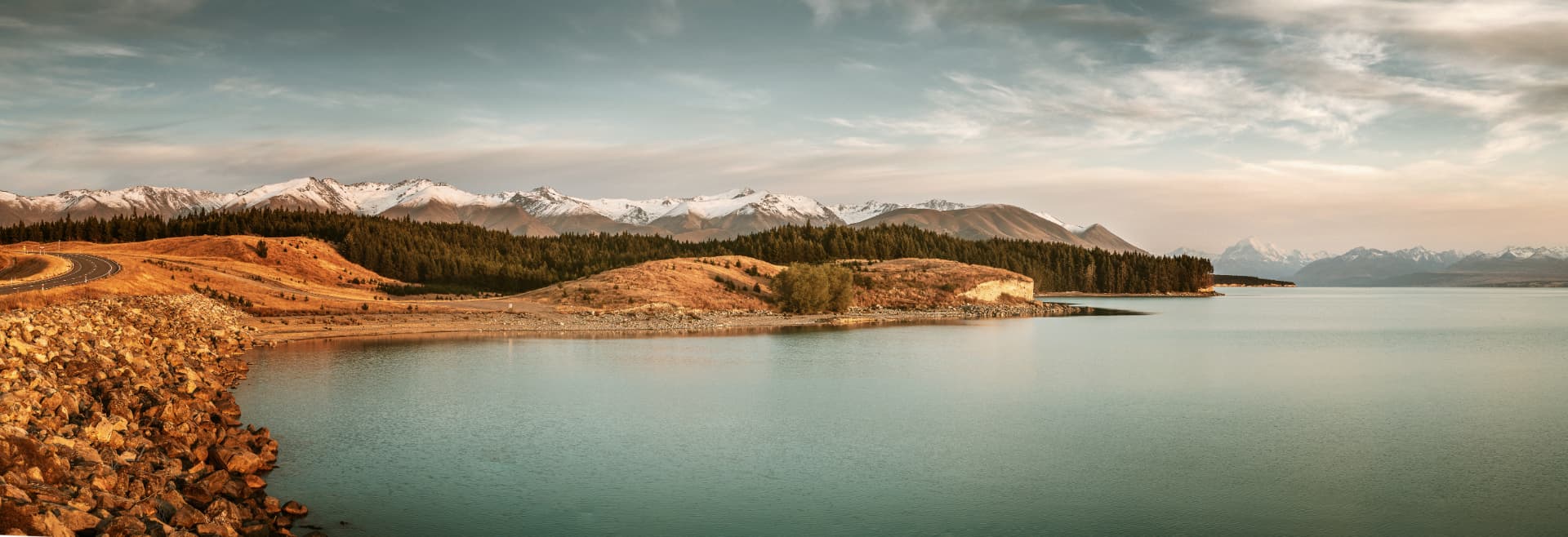 Alpine lake with snow-capped mountains at dusk